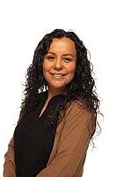 Analizeth stands in front of a white background. She is smiling towards the camera.